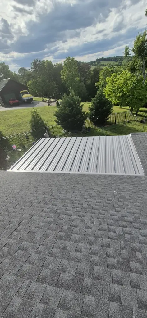Metal porch roof next to shingles with an East Tennessee mountain view